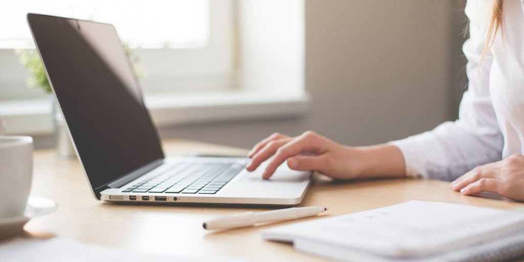 Woman working on laptop searching for workplace manslaughter