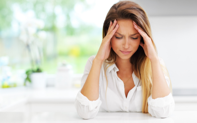 A woman is stressed about managing flexible work arrangements.