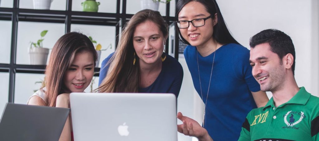 A group of people at work looking at their laptop searching for activities during Safe Work Month in Australia